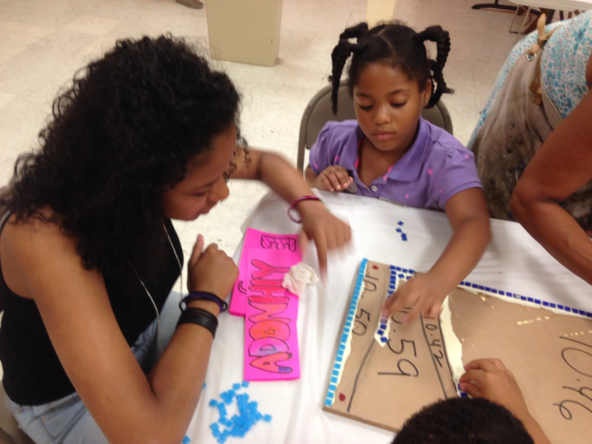 Students at St. A&M are engaged while working on a group mosaic. 