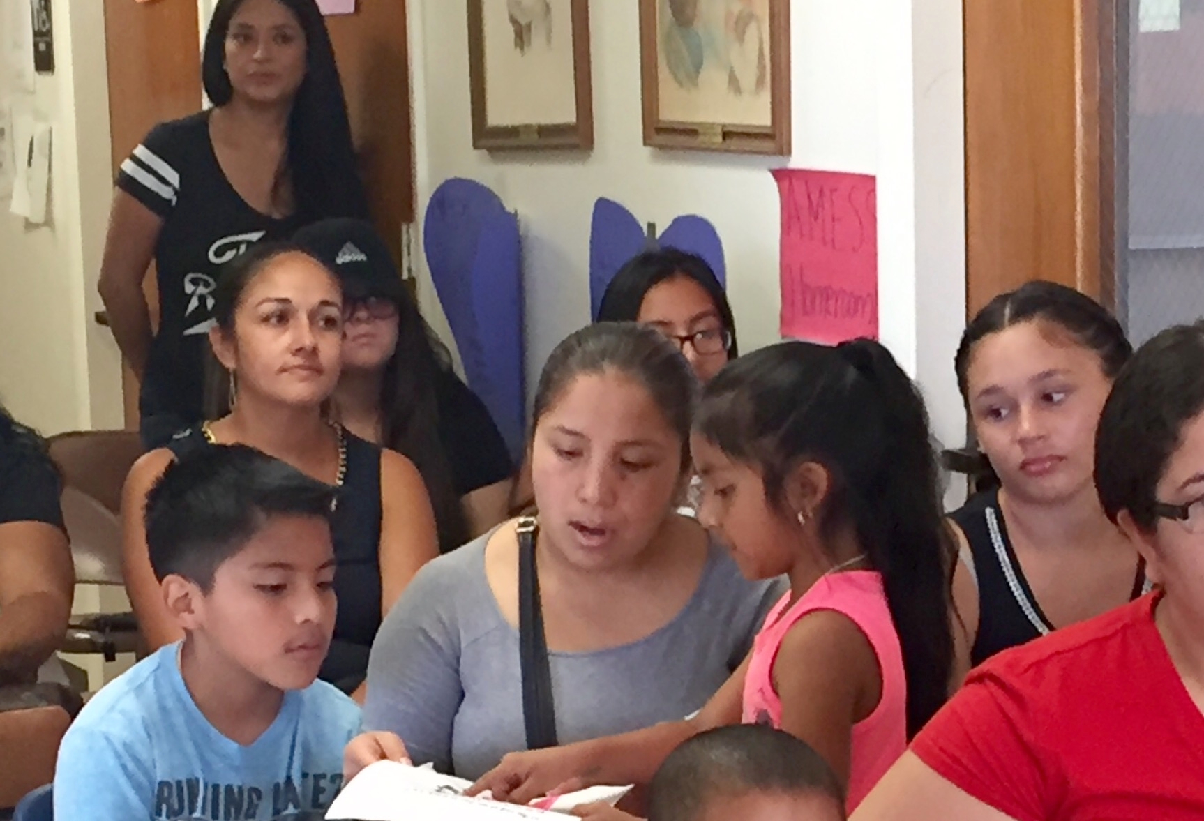 An excited young person shows proud mom all of her hard work this summer.