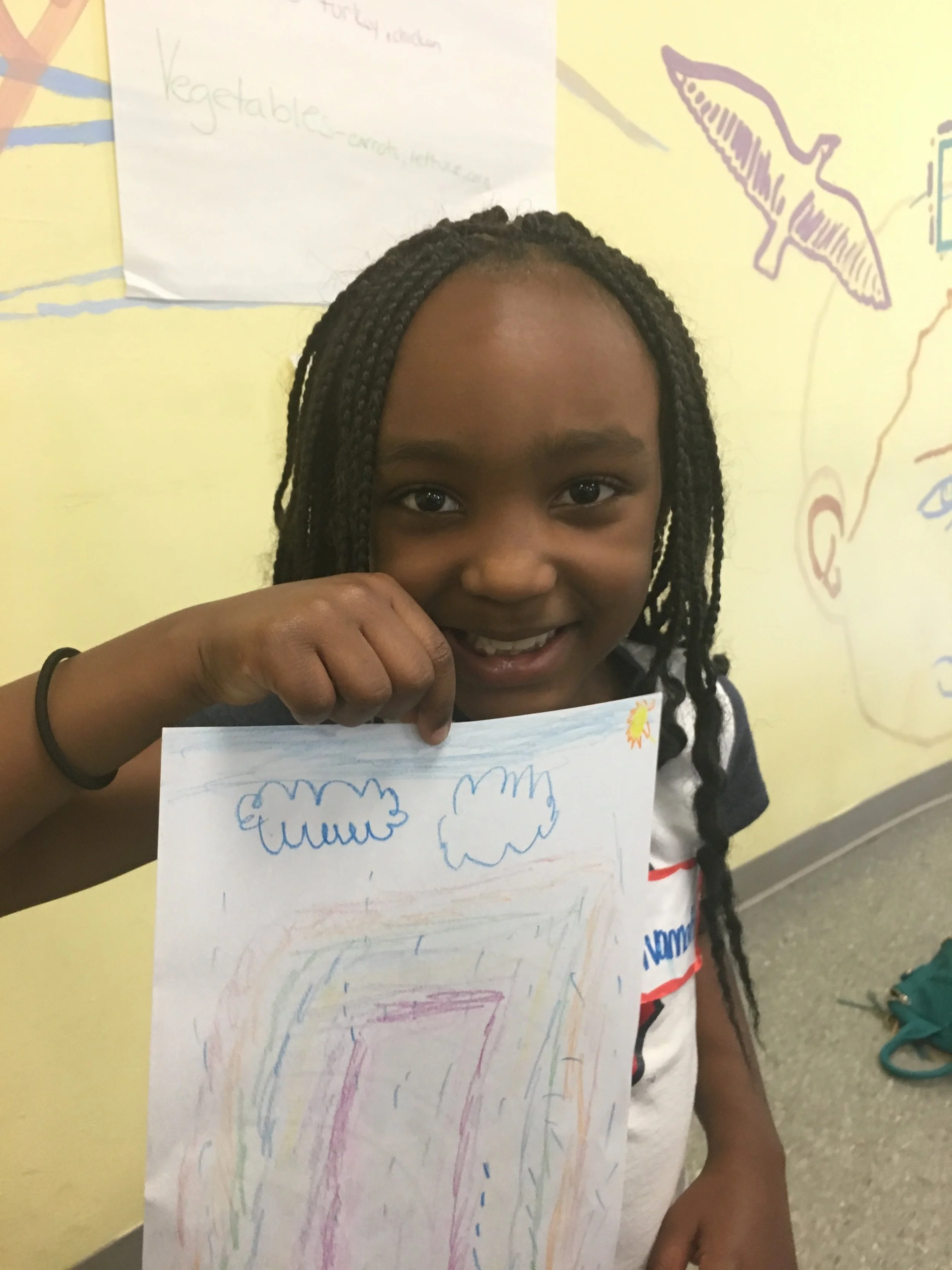 A camper presenting her take on the rainbow after completing an activity on the foods in a "healthy rainbow".