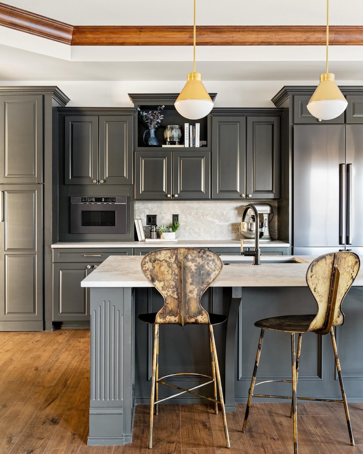 Updating the hosting spaces on both levels of the home were an important piece of this project 🥂

The white kitchen cabinets felt underwhelming with our overall design end goal so we decided to paint them a smokey dark gray to give the kitchen its o