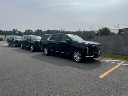 SUV parked waiting for VIPs at event Multiple SUVs booked for VIP event