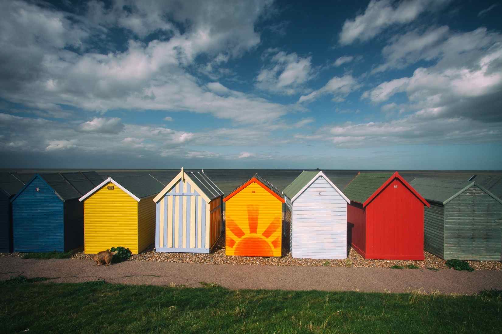 Seven small fishing huts painted in colourful ways representing different types of therapy