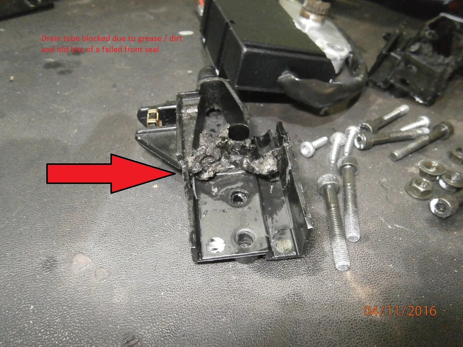 Drain Tube blocked due to Grease / Dirt and bits of a failed front seal.