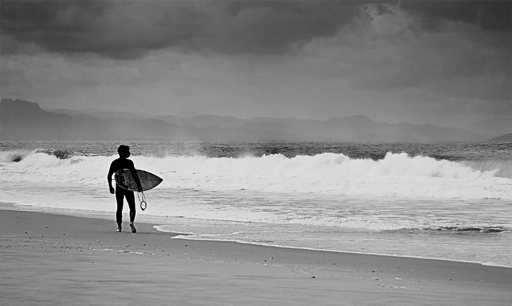 A Rider looks for the perfect spot to paddle out.