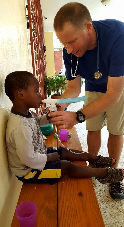 Trying to explain to Kiko how to do a breathing treatment through a translator.