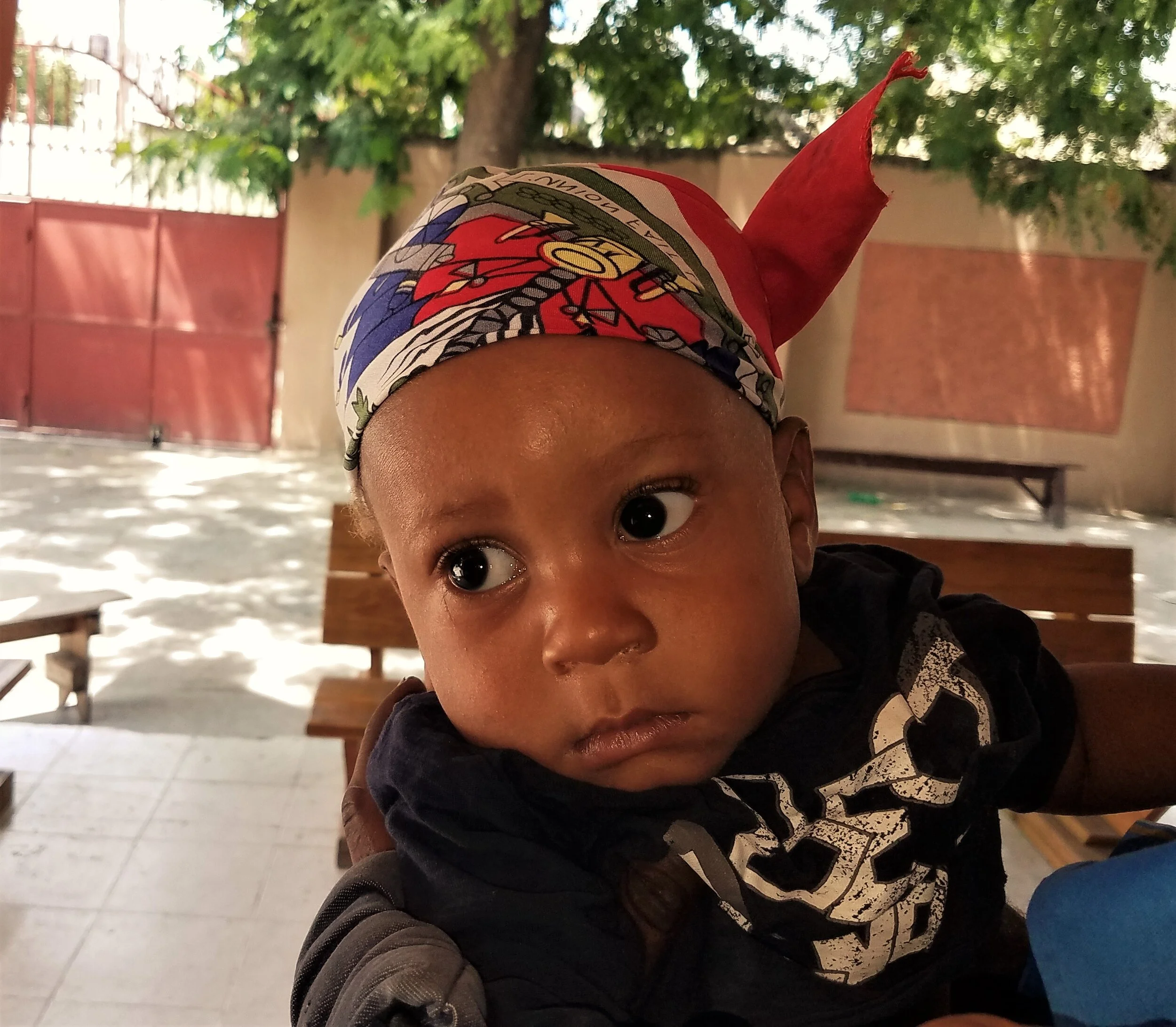 This little man is still showing his Haiti pride with his Haiti flag doo rag as he is leaving malnutrition clinic.