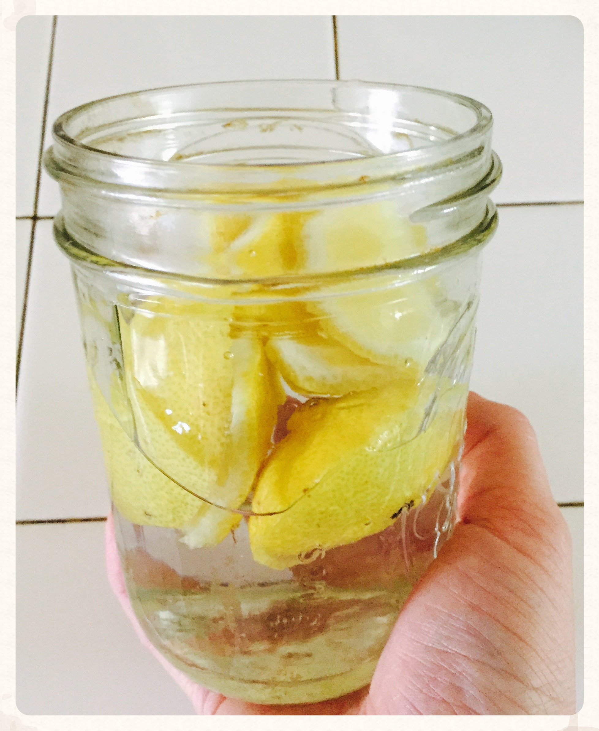 Infusing vinegar with lemon rinds.