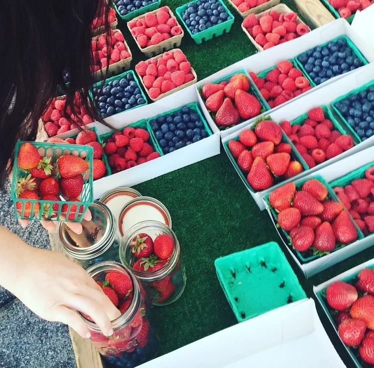 Transferring strawberries to my own jars at the farmers market. 