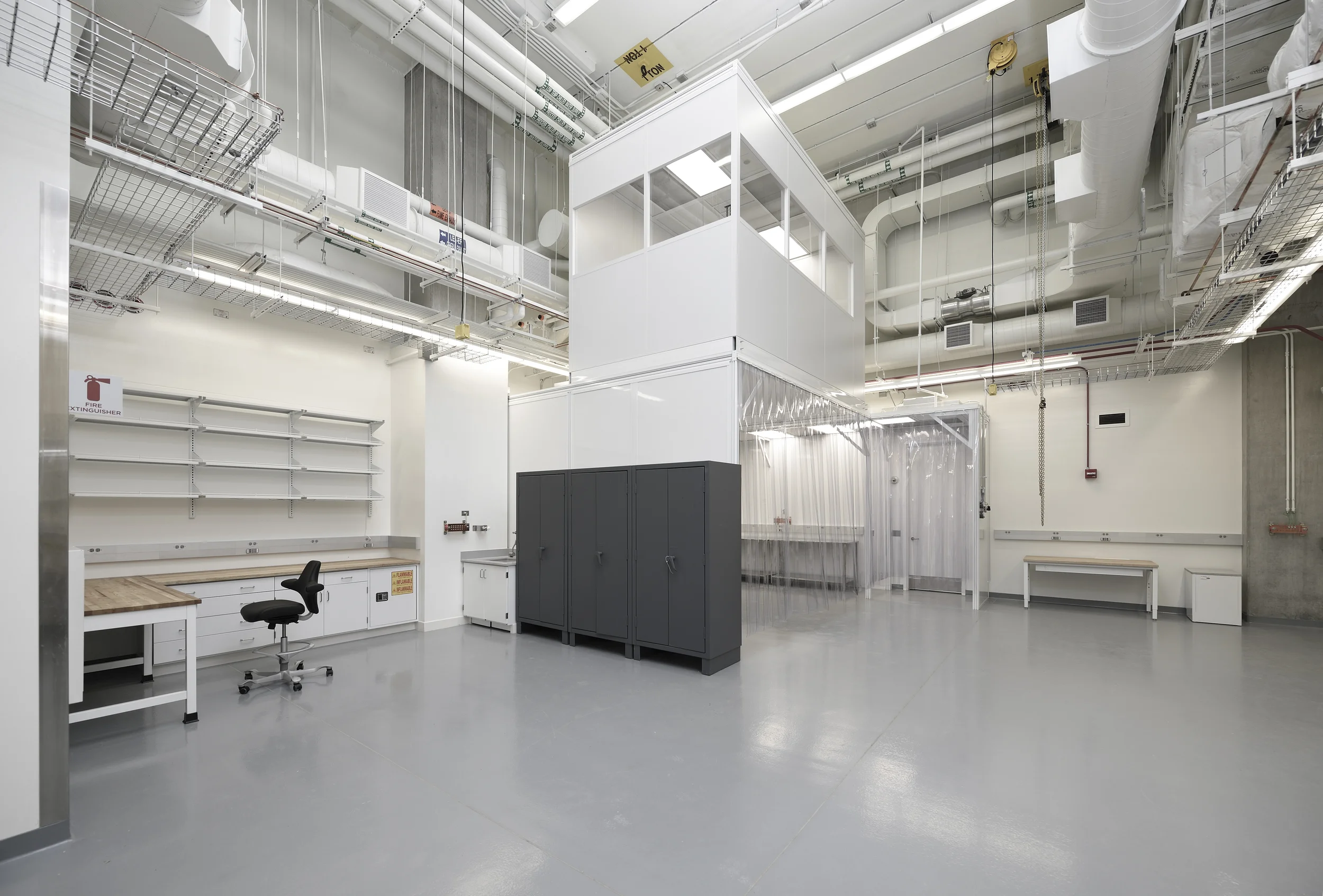 University of Chicago | Chicago, Illinois This research institution is known for asking architects to do the impossible and this project was no exception. Its Astrophysics department was creating nine separate electronics labs on three floors, and each lab would house tenants with different needs and specialized equipment. We created a detailed cross-referencing and documentation matrix to guide the complex planning process. And we designed flexible spaces with clean, white walls and ceilings, custom workbenches and storage systems. These labs could easily accommodate such equipment as a 17-foot high clean room tent with a hoist crane and a room that shielded electromagnetic radiation. 