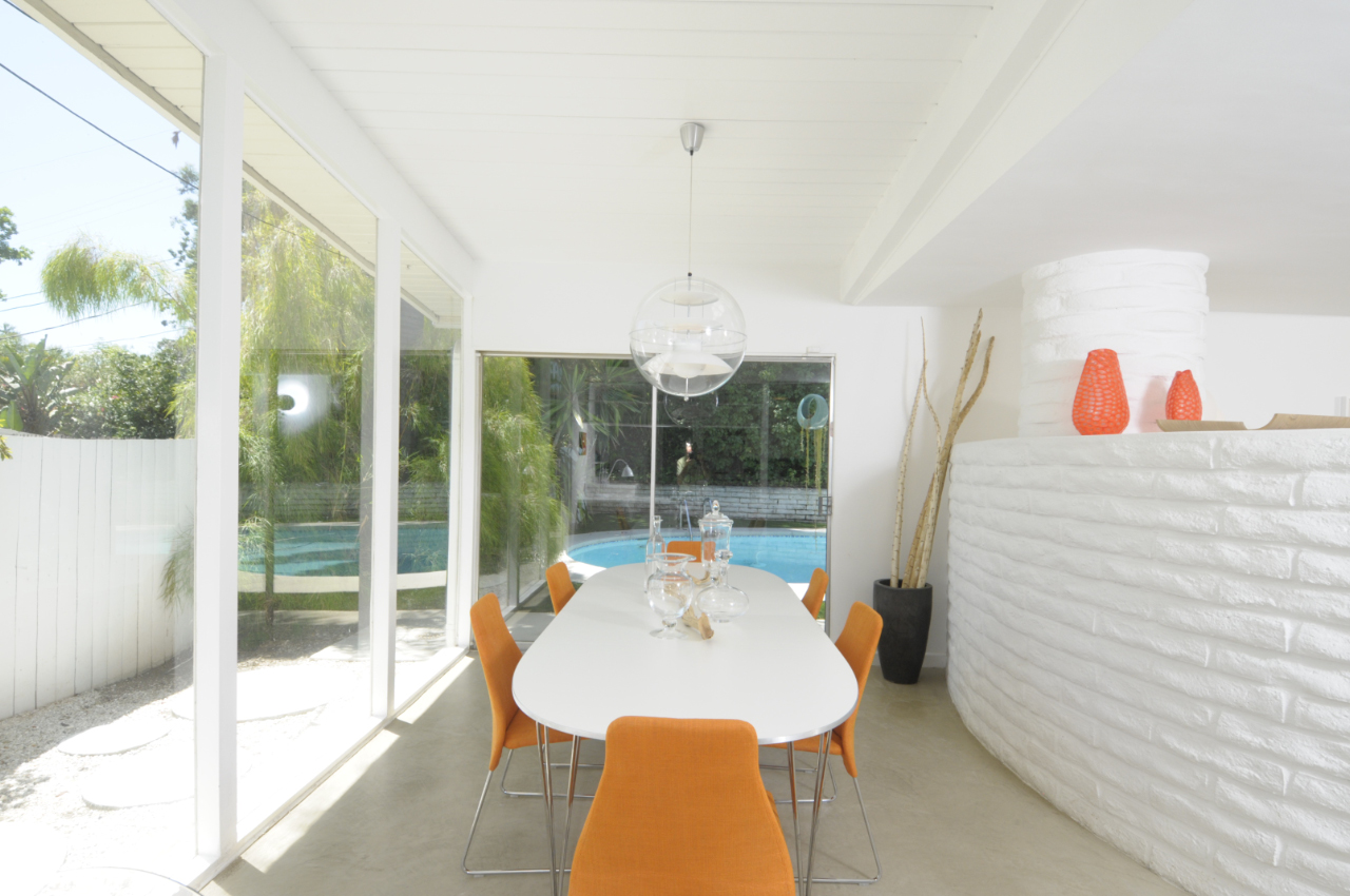 Clean white spaces flooded with natural light flow to the outdoors through extensive glazing. 