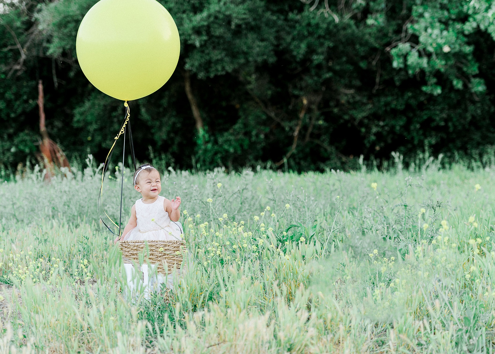 Baby with yellow balloon