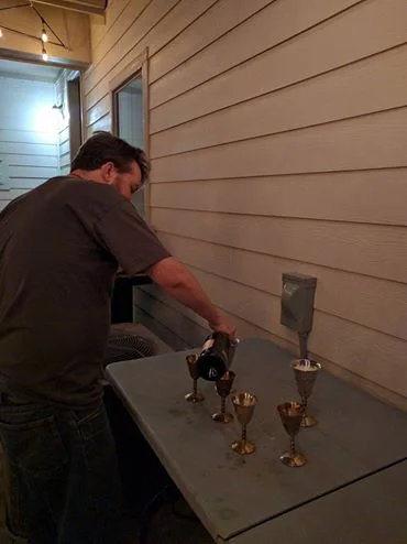 Devon pours sparkling wine to celebrate the end of a very long campaign. 