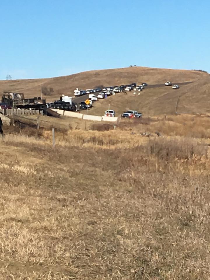 Militarized police, sons of earth whom the Native women also welcome to join the circle of peace.