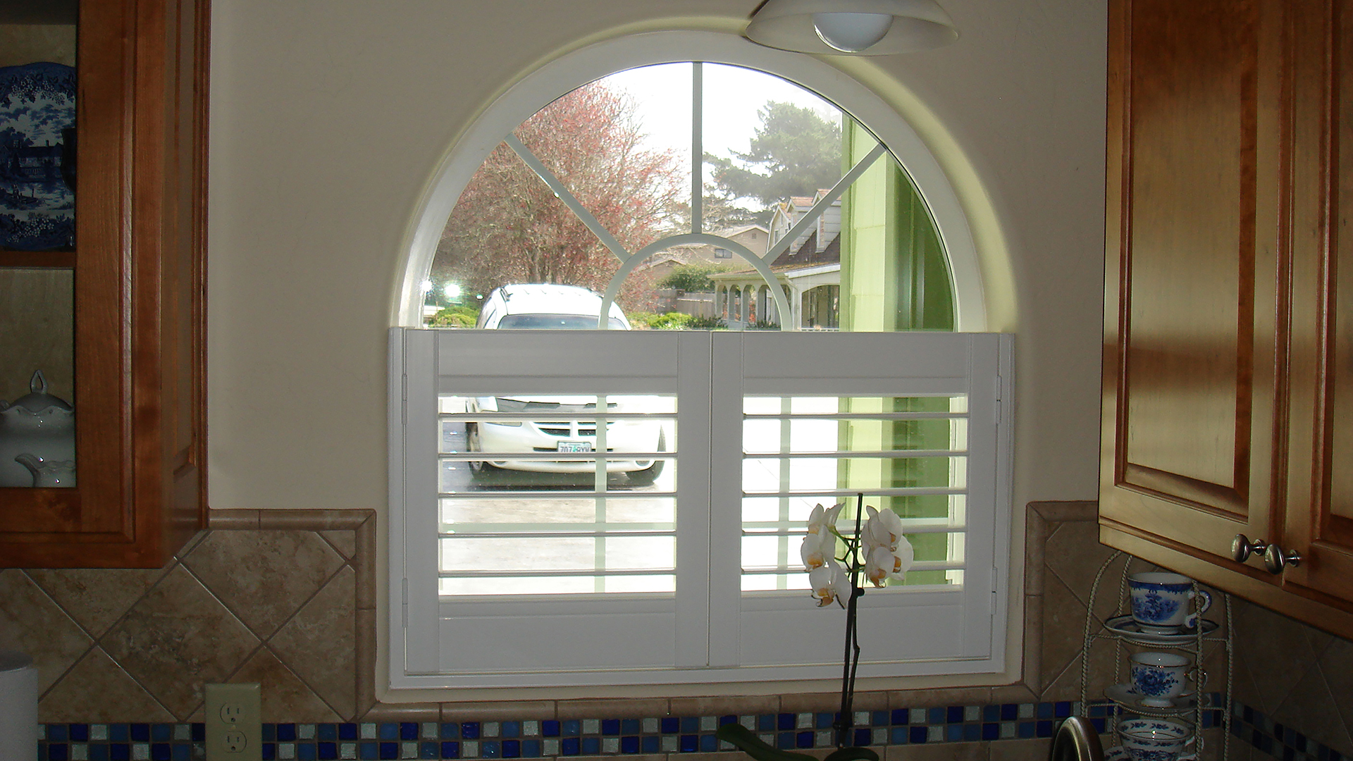 Cafe Style Vinyl Shutter in arched window.jpg
