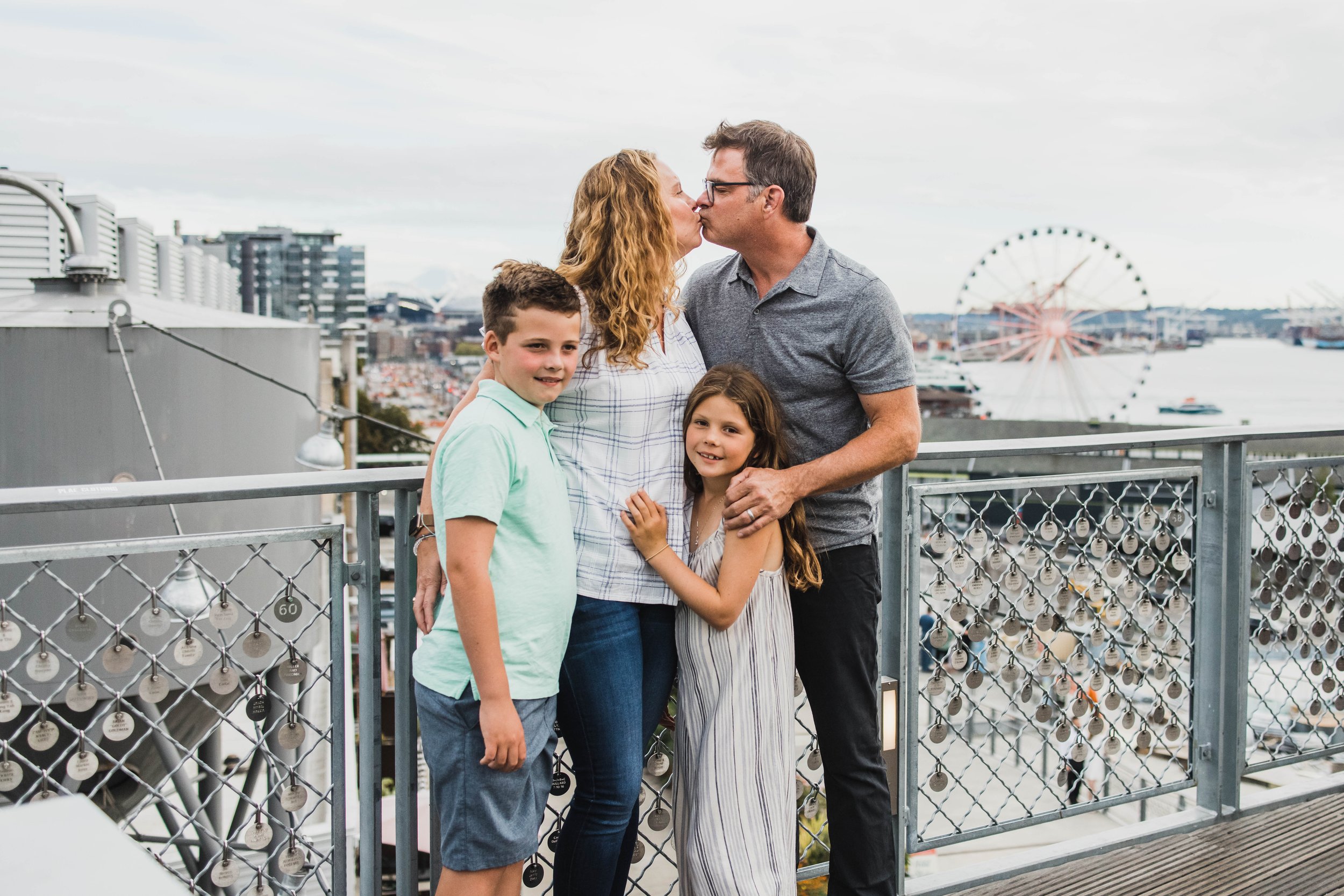 Seattle family photography, Pike Place Market, Elliott Bay views, Seattle Great Wheel, affectionate family portrait.