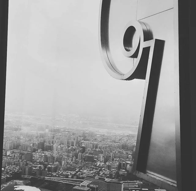 &quot;They will see us waving from such great heights.&quot; #taipei #taipei101 #taiwan #travel #highup #suchgreatheights #blackandwhite #reflection #buildings #city #horizon #overcast #igers #lyrics #台北 #台湾 #台北101 #adventure #observatory