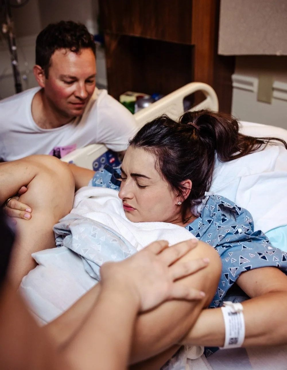 man supports woman who is pushing in labor and delivery at boca raton hospital