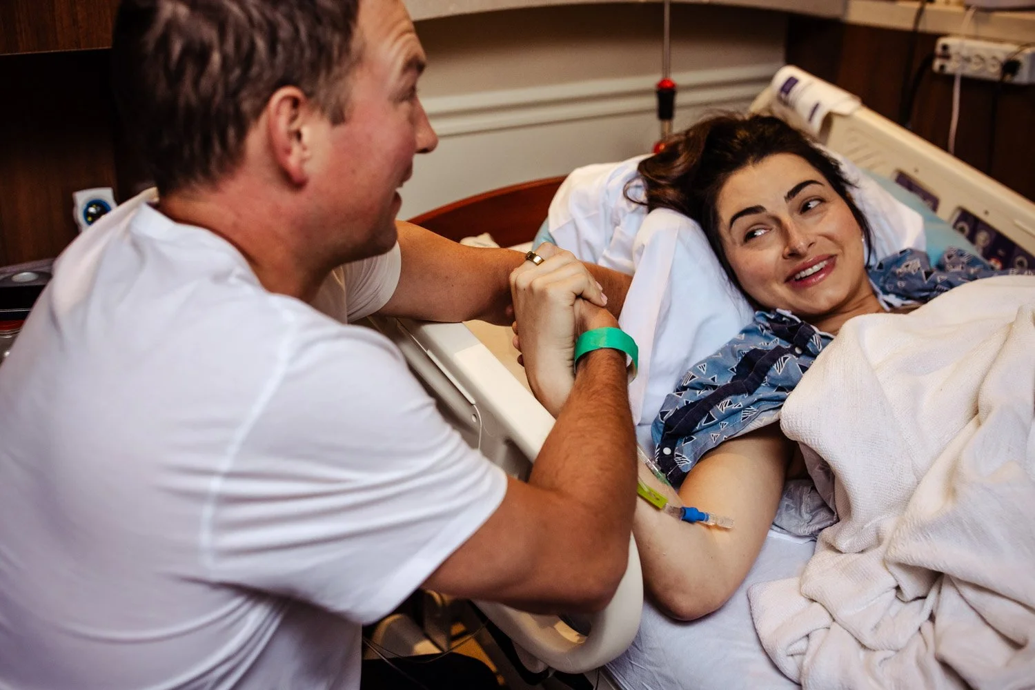 laboring woman smiles at husband in labor and delivery in boca raton hospital