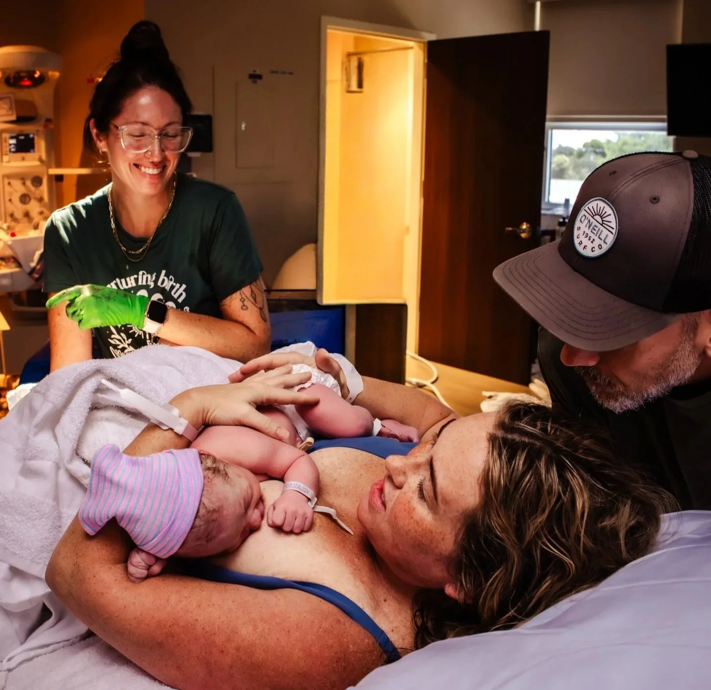 mom holds newborn baby immediately after unmedicated boca regional birth with jessica hernandez bloom midwifery