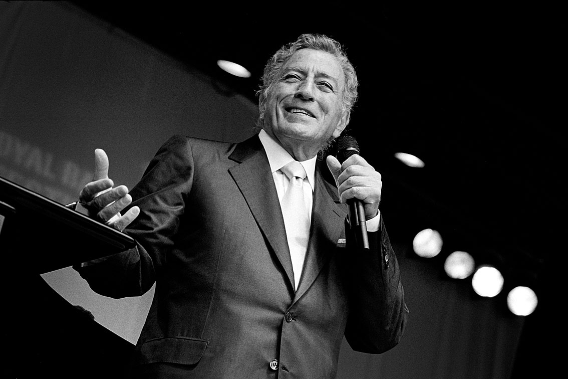 Anthony Dominick Benedetto (born August 3, 1926), known professionally as Tony Bennett, is an American singer of traditional pop standards, big band, show tunes, and jazz. He is also a painter, having created works under the name Anthony Benedetto that are on permanent public display in several institutions. He is the founder of the Frank Sinatra School of the Arts in Astoria, Queens, New York. Born and raised in Astoria to an Italian-American family, Bennett began singing at an early age.