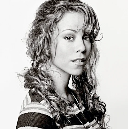 Mariah Carey (born March 27, 1969 or 1970) is an American singer, songwriter, record producer, and actress. In 1990, she rose to fame with the release of "Vision of Love" from her eponymous debut album. The album produced four chart-topping singles in the US and began what would become a string of commercially successful albums which solidified the singer as Columbia's highest selling act. Carey and Boyz II Men spent a record sixteen weeks atop the Billboard Hot 100 in 1995–1996 with "One Sweet Day", which remains the longest-running number-one song in US chart history. Following a contentious divorce from Sony Music head Tommy Mottola, Carey adopted a new image and traversed towards hip hop with the release of Butterfly (1997). In 1998, she was honored as the world's best-selling recording artist of the 1990s at the World Music Awards and subsequently named the best-selling female artist of the millennium in 2000
