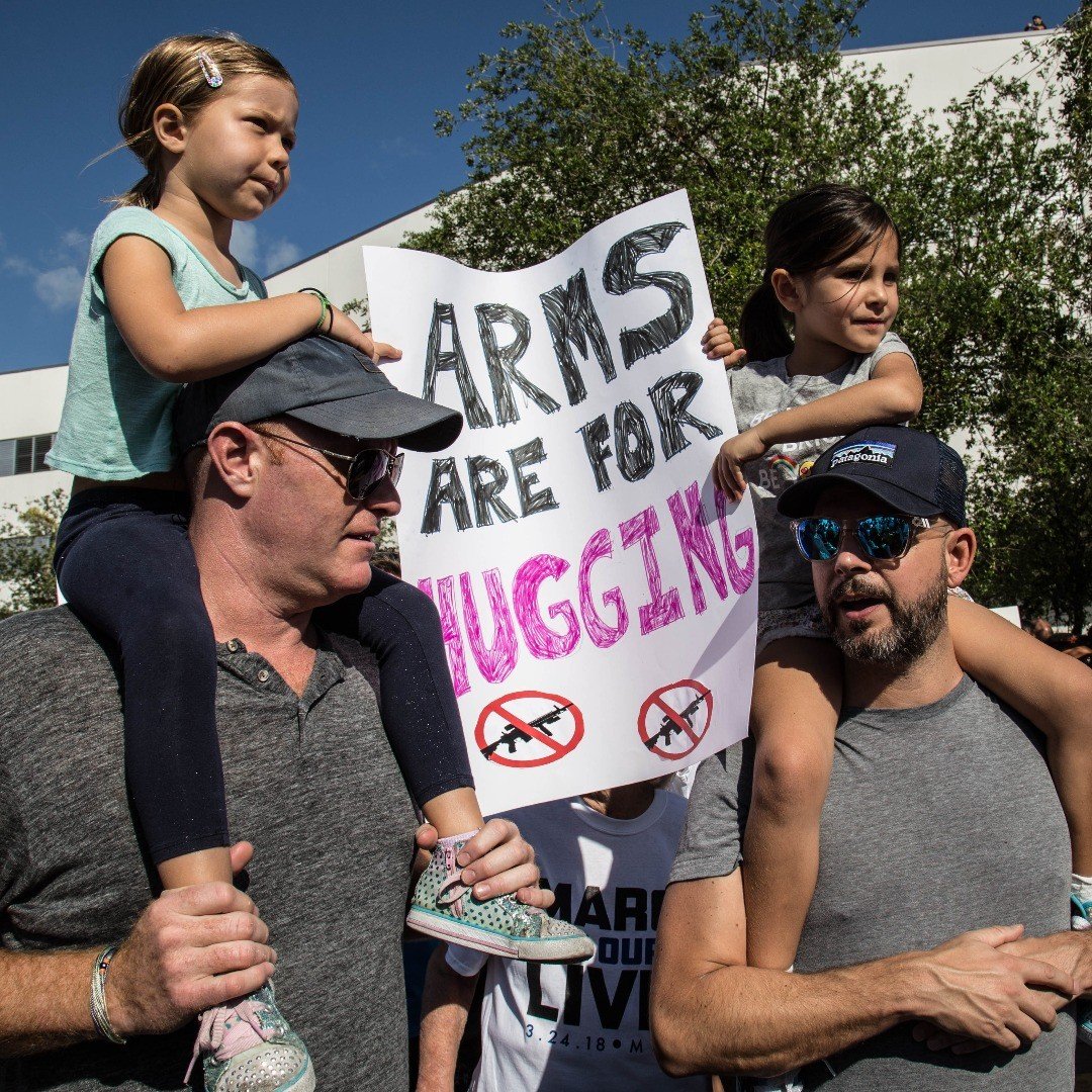 These Dads! "Arms are for Hugs" at the March for Our Lives event in Miami Beach