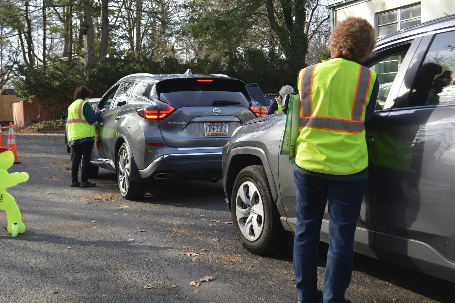 JFC volunteers helping neighbors in cars during a food distribution