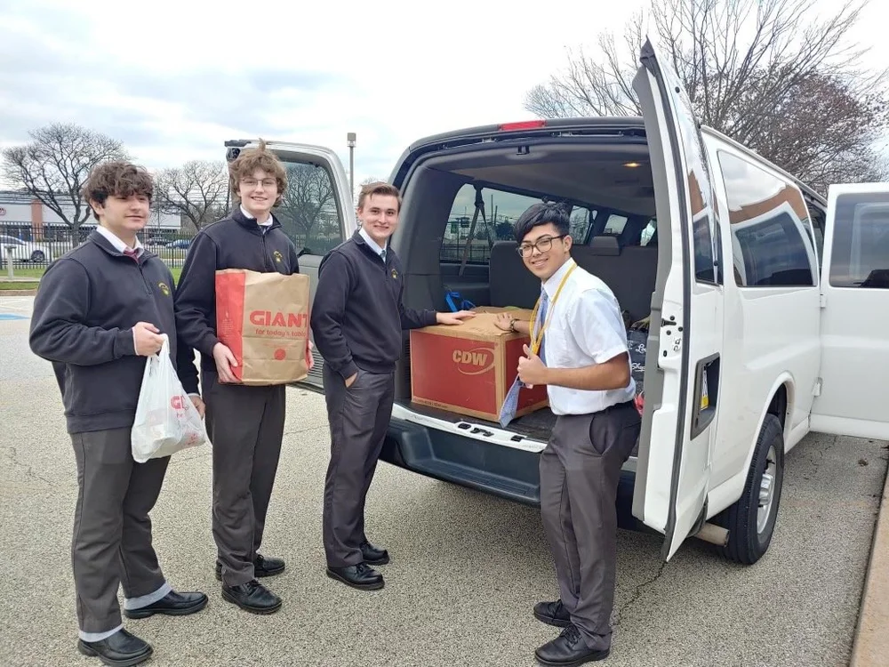 Community members bringing a collection of food to Jenkintown Food Cupboard
