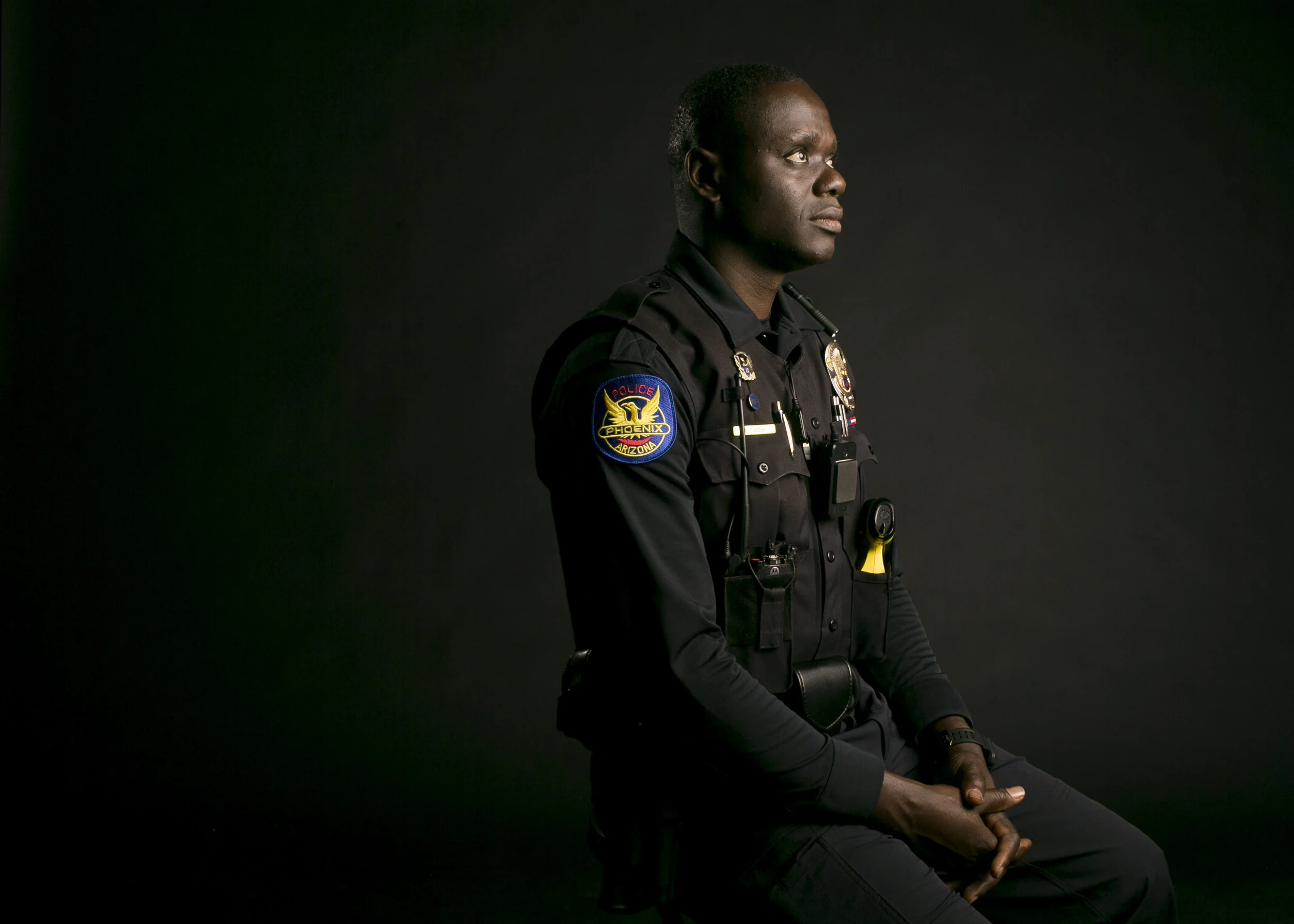  Phoenix police officer and Tongan refugee Germain Dosseh sits in the studio at the Arizona Republic in Phoenix 
