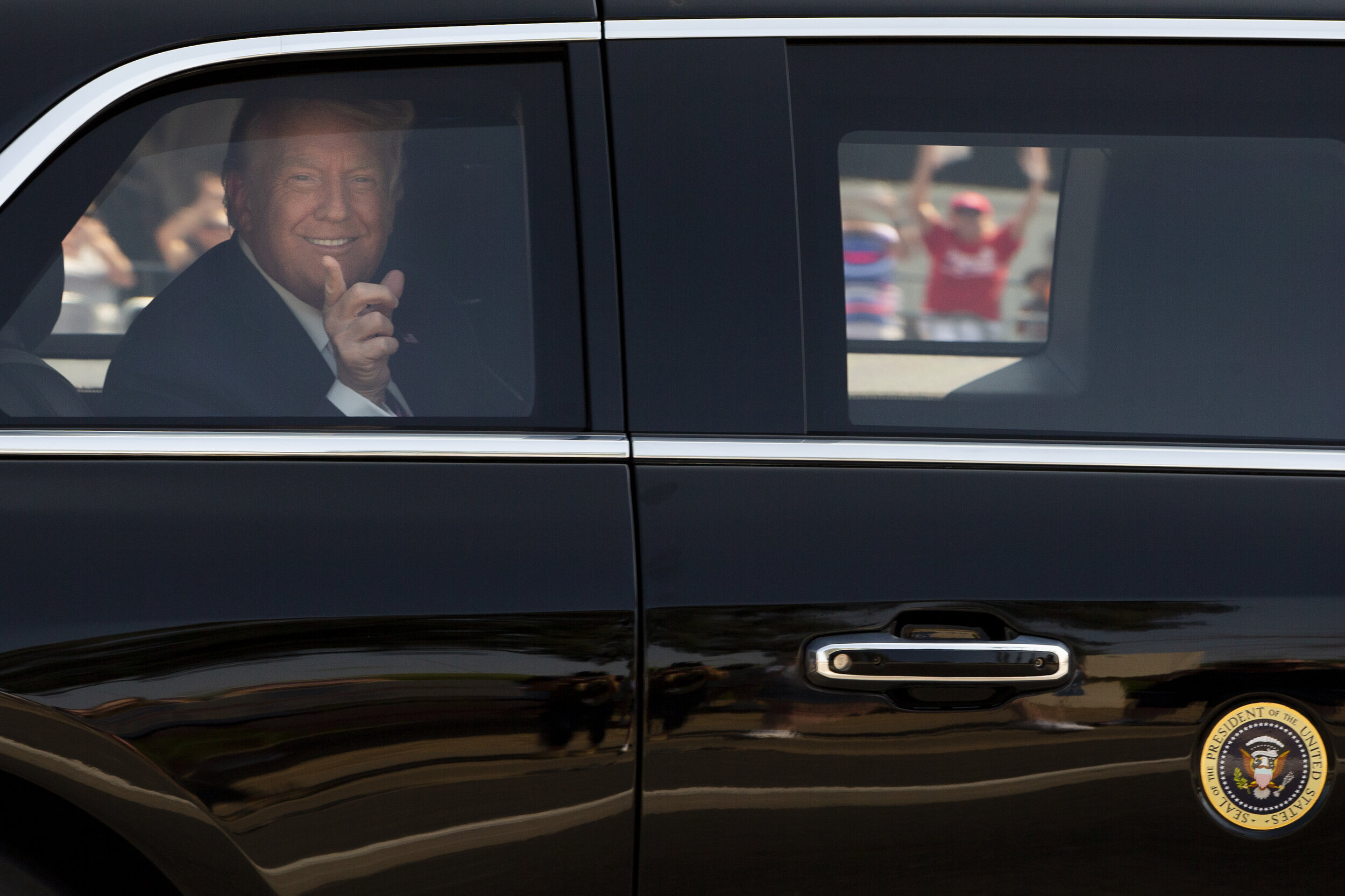  President Donald Trump greets supporters as he arrives at the Arizona Grand Resort to speak at a "Latinos for Trump" roundtable in Phoenix on Sep. 14, 2020. 