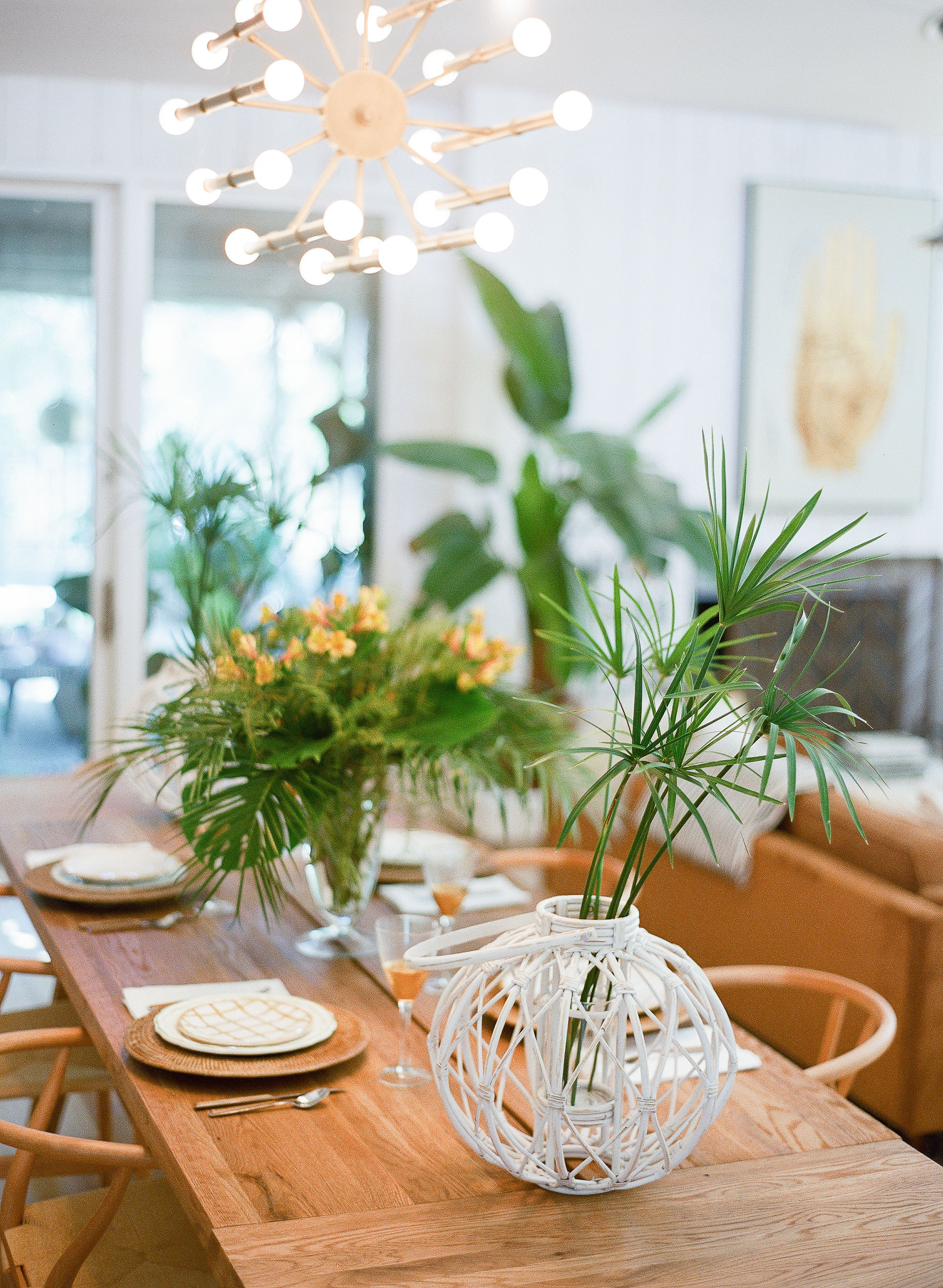 Natural tablescape with wooden elements and tropical plant centerpiece