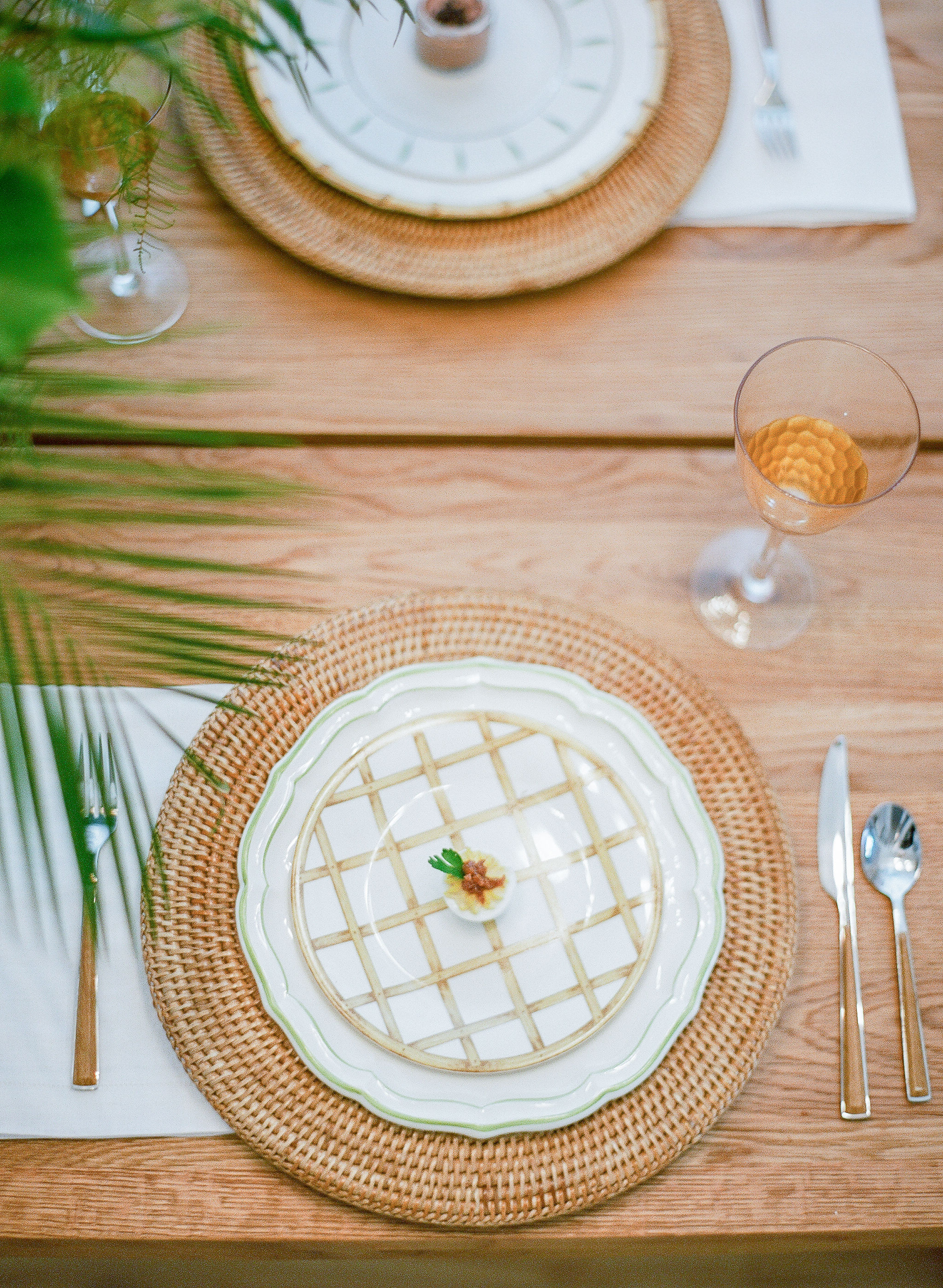 mix and match natural rattan and green place setting from Vieuxtemps in Charleston SC