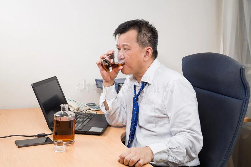 frustrated-stressful-asian-manager-drinking-hard-liquor-o-business-office-65161951.jpg