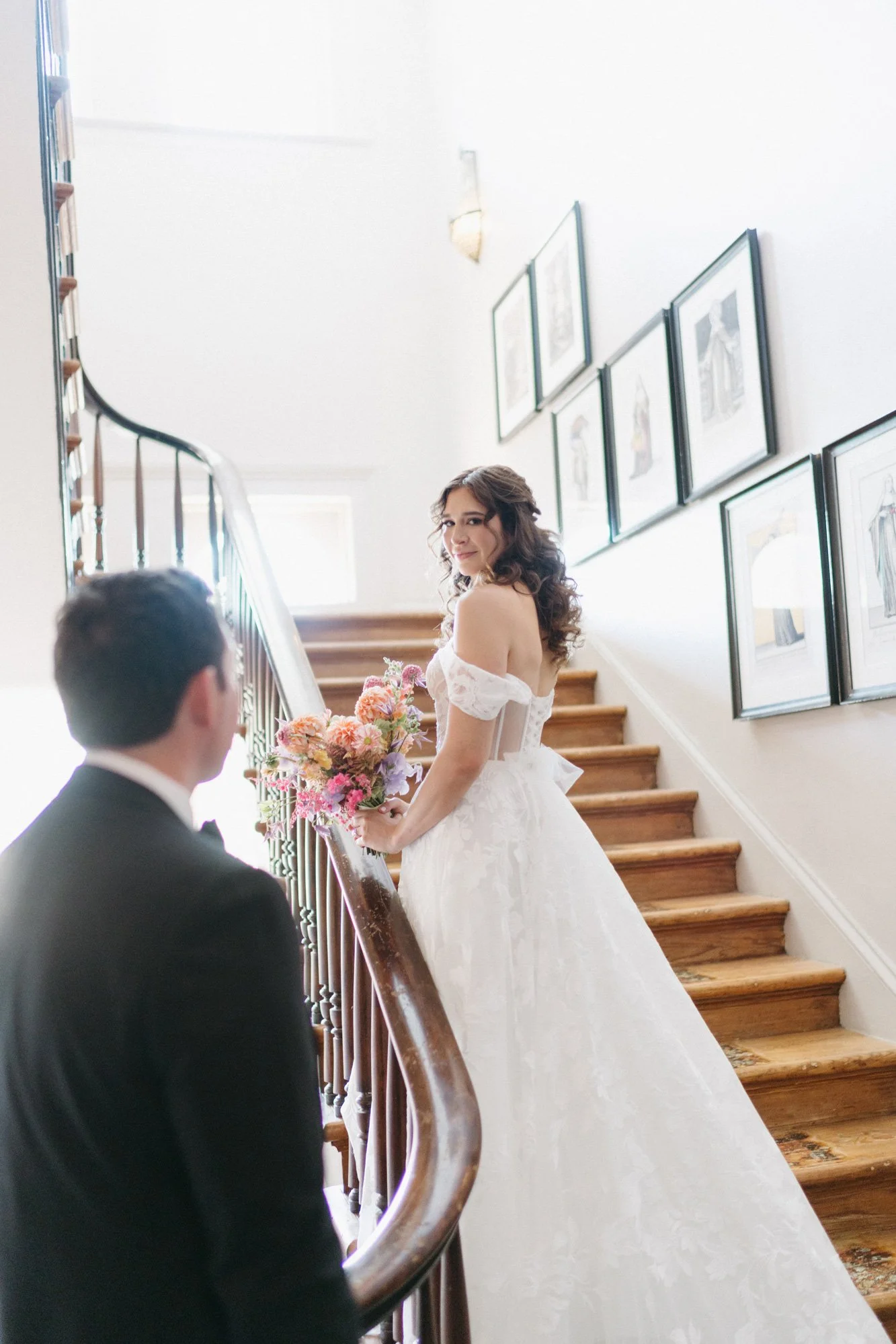 Missy walking down the staircase in her wedding gown.
