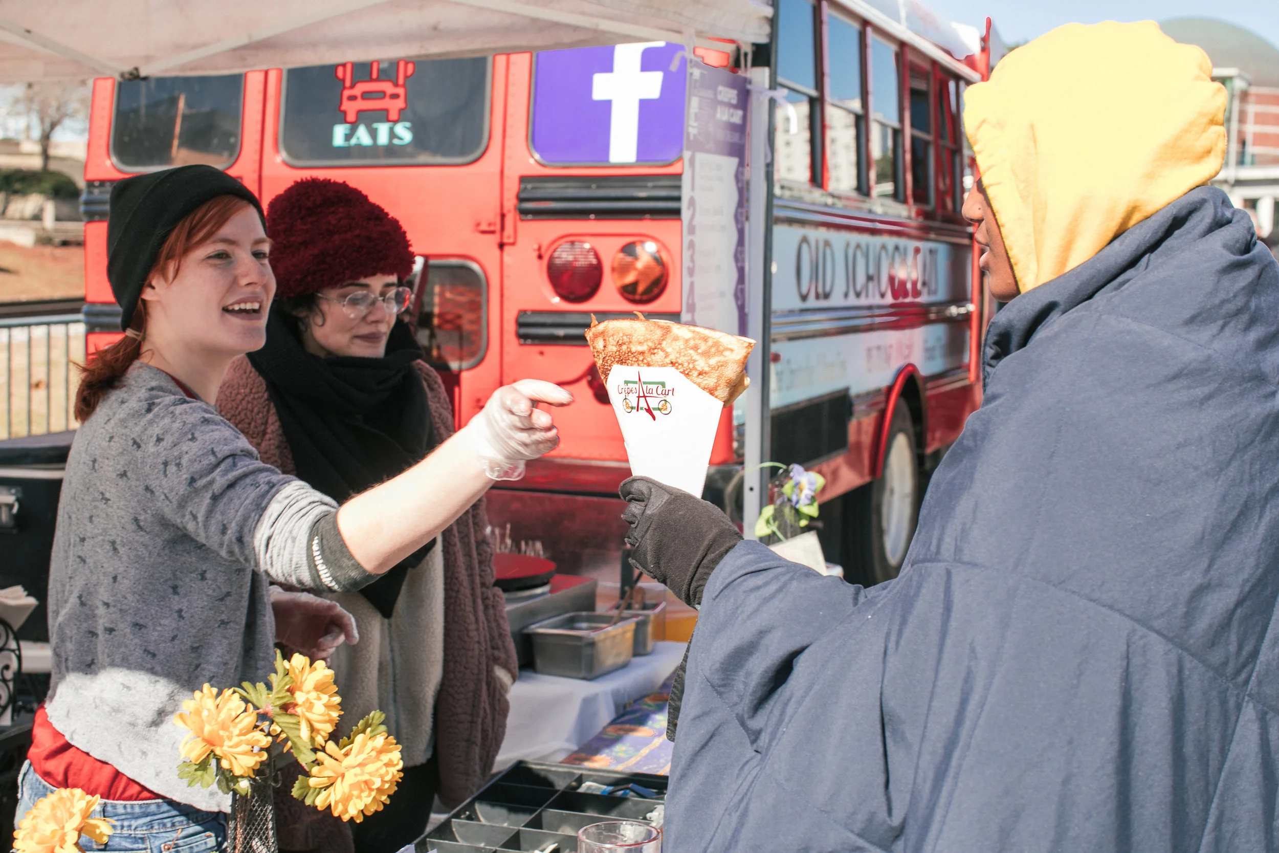 The team at NOLA-based Crepes a la Cart hands off one of their sweet or savory treats to a heavily bundled customer. OA
