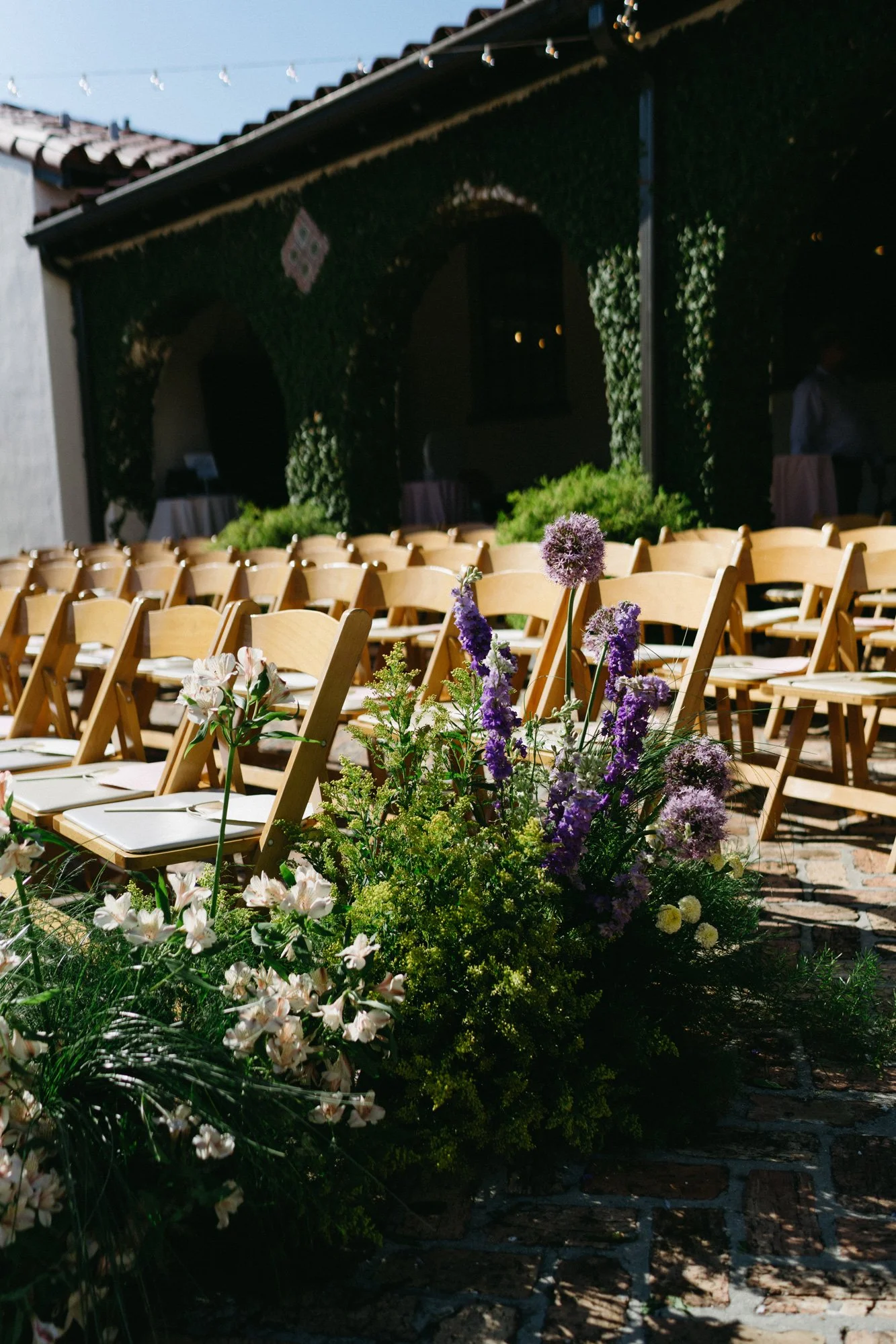 Outdoor ceremony seating arranged in the courtyard.