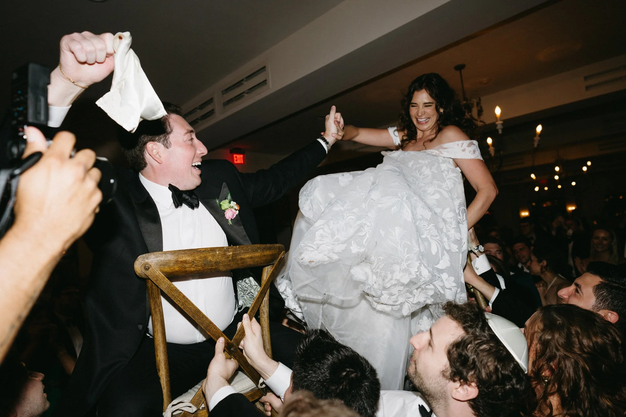 Missy and Alec lifted in chairs during the hora at their wedding reception.