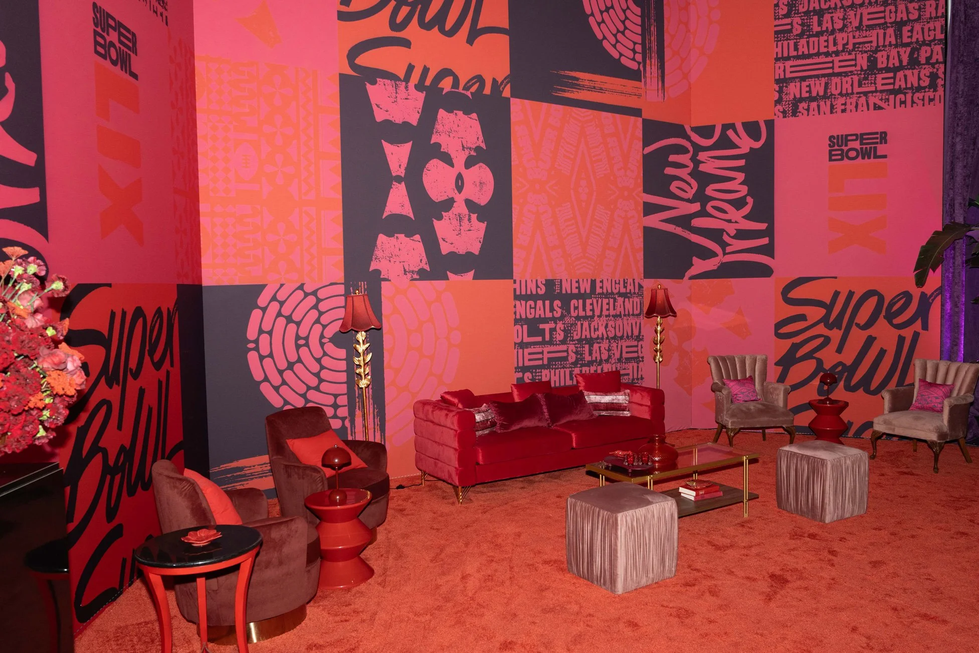 Lounge area featuring bold red Super Bowl LIX graphics and seating.