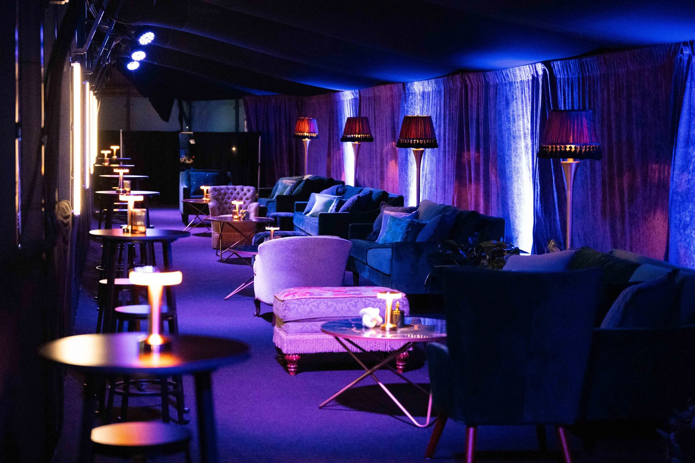 Lounge seating and colorful lighting inside the Commissioner’s Party.