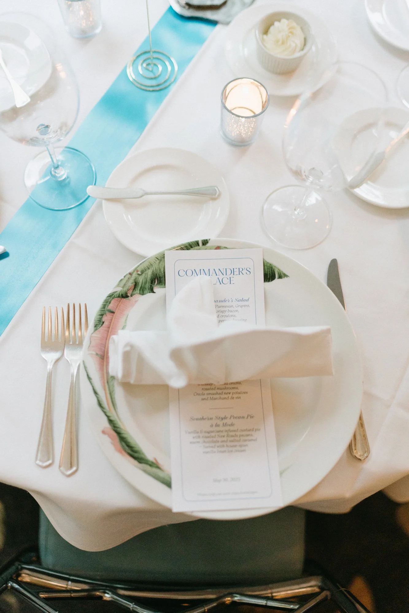 Wedding place setting with personalized menu and table details.