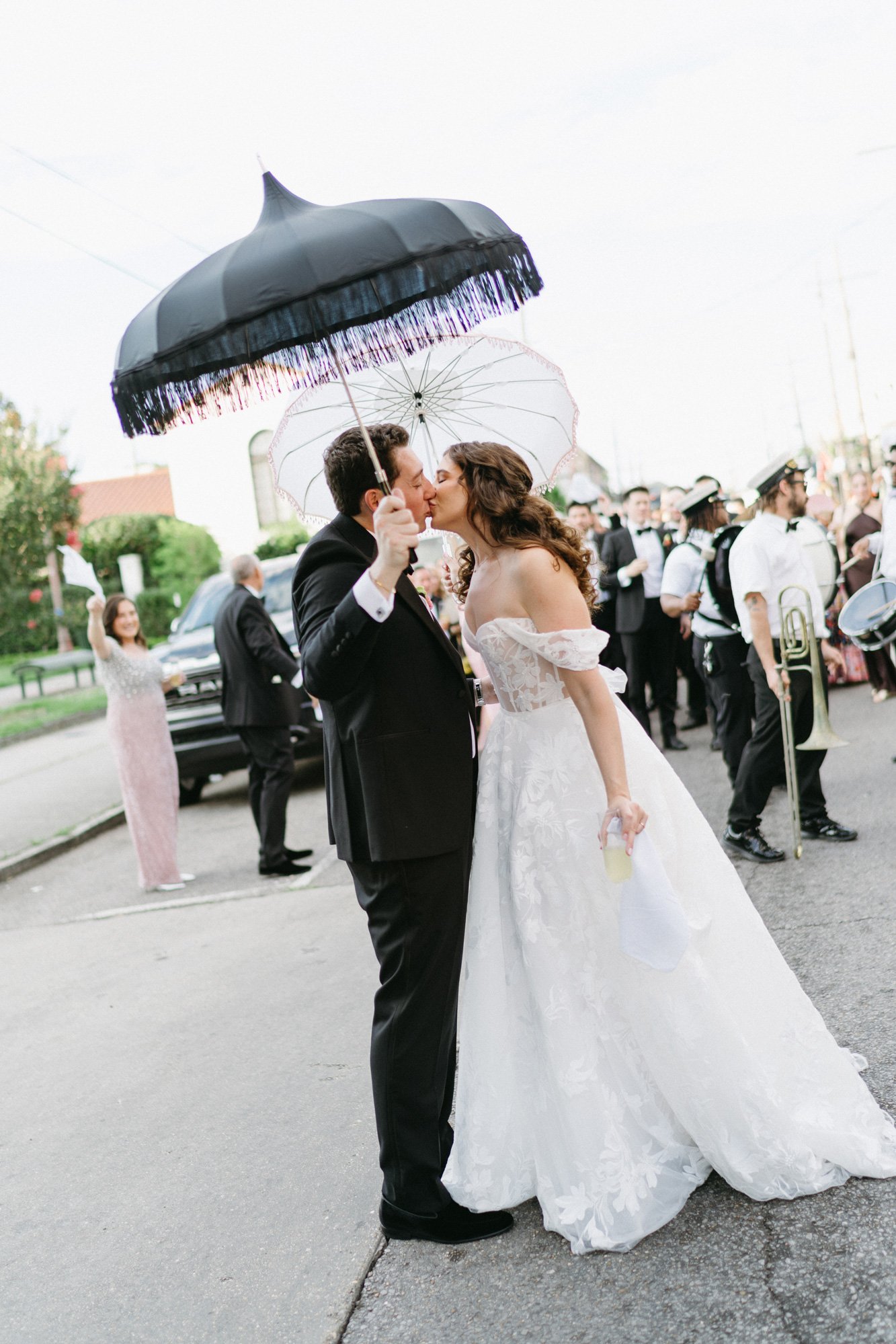 Missy and Alec kissing as guests celebrate around them.