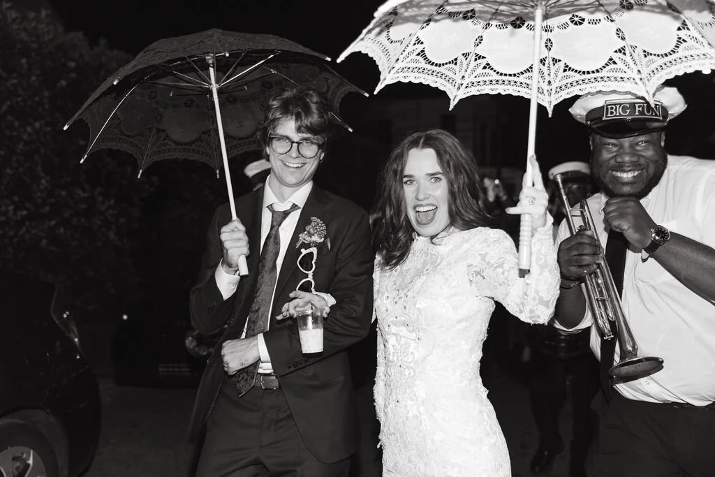 Brooke and Niels posing together beneath a parasol.