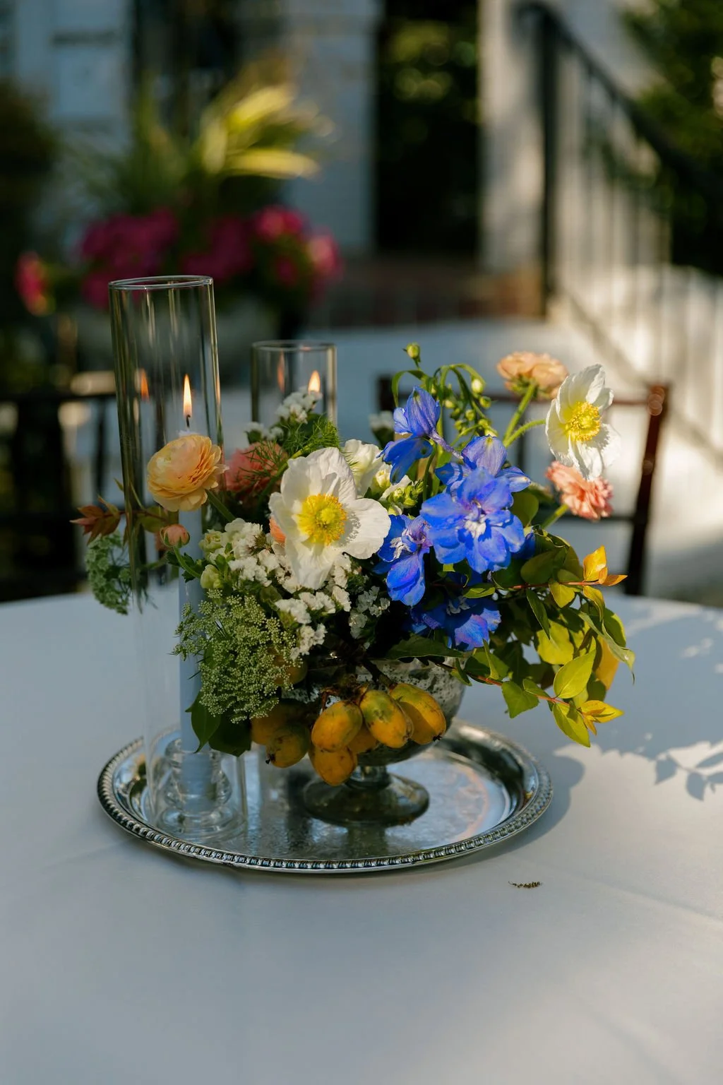 Colorful floral centerpiece with blue, yellow, and orange blooms.