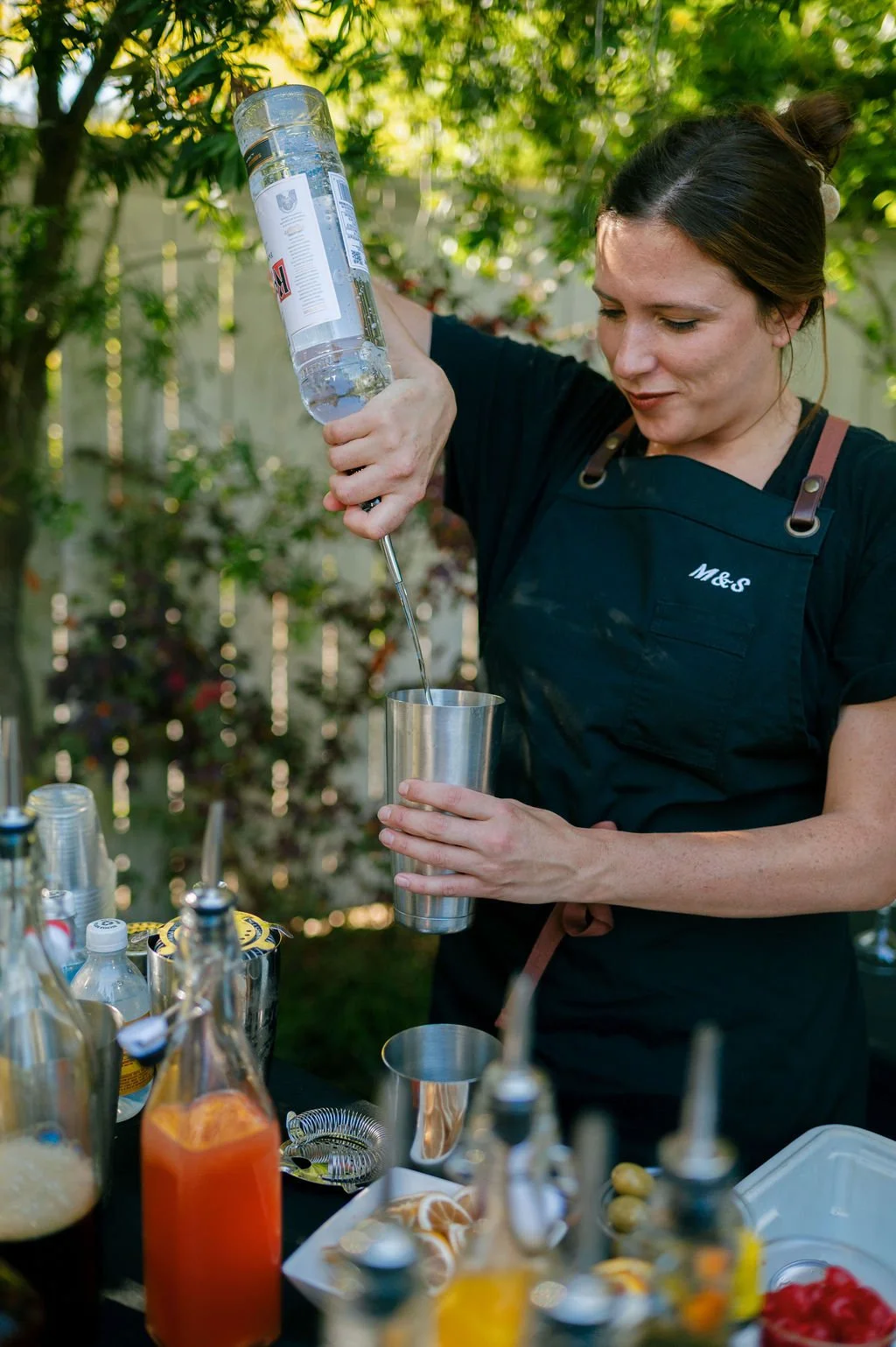 Bartender preparing drinks for wedding guests.