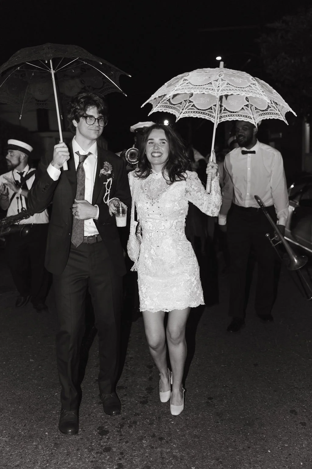Brooke and Niels celebrating beneath a parasol at the reception.