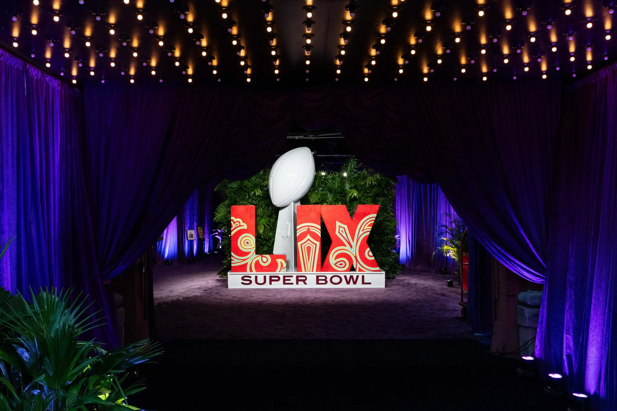 Super Bowl LIX installation illuminated at the event entrance.