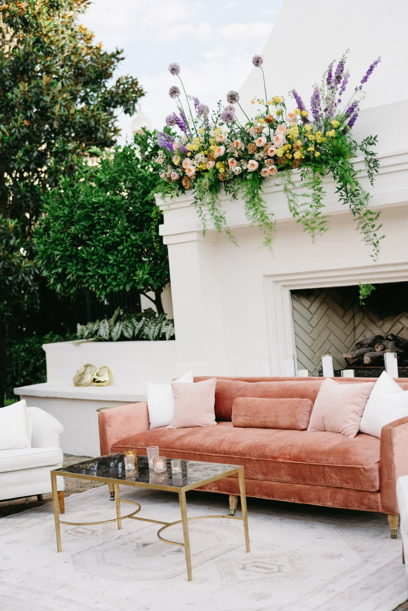 Lounge area decorated with florals and soft seating.