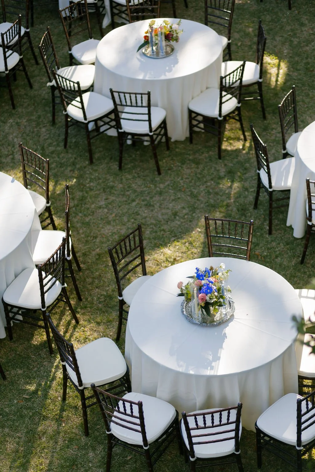 Reception tables arranged throughout The Mazant’s garden.