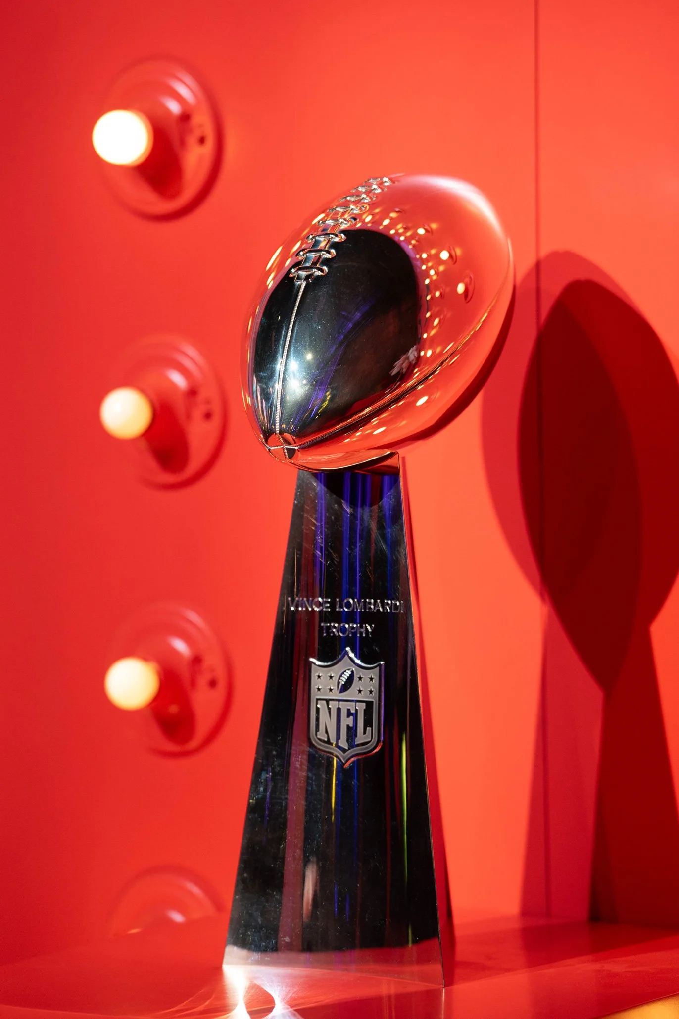 Vince Lombardi Trophy displayed against colorful Super Bowl LIX décor.