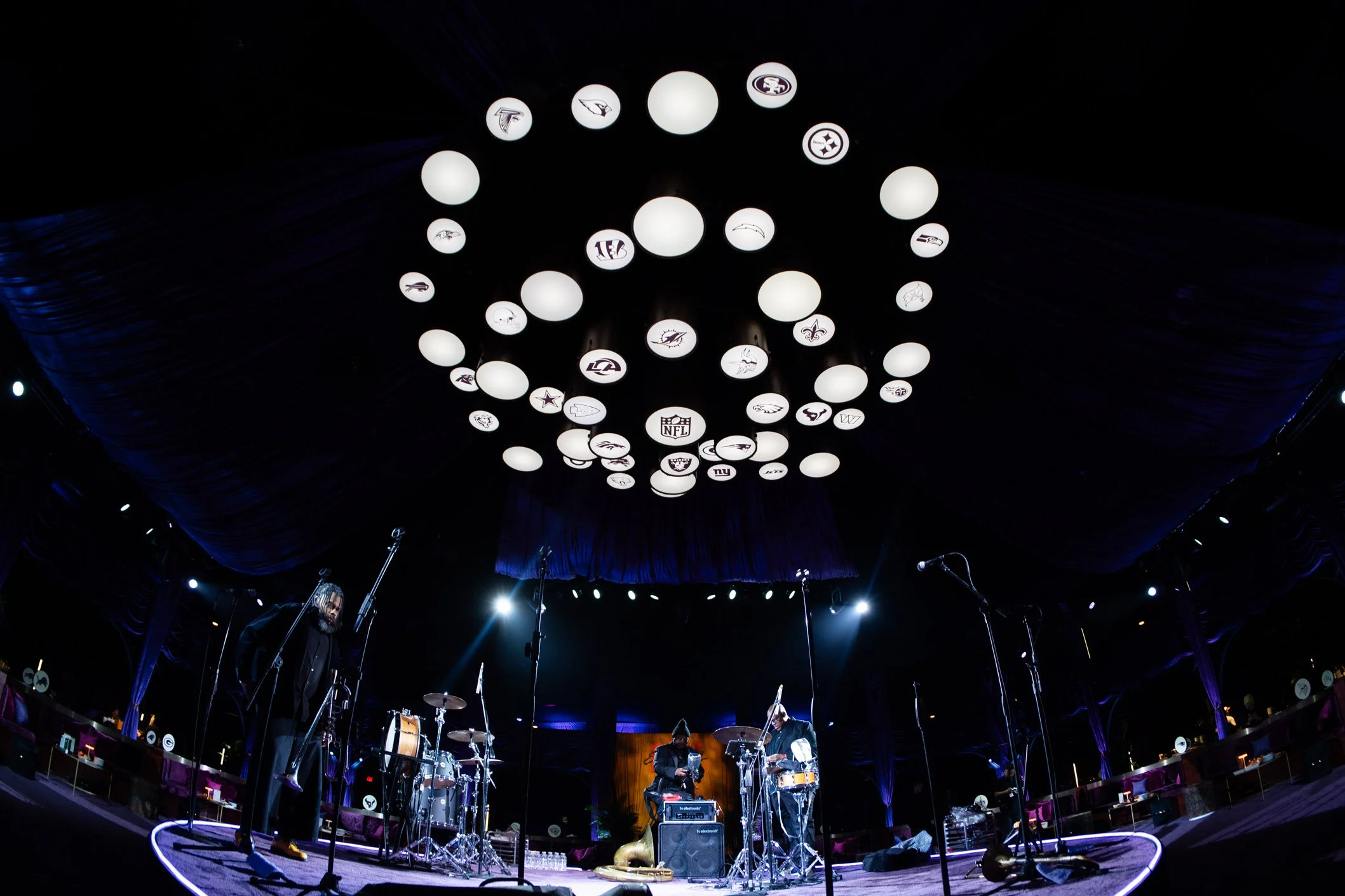 Circular overhead light installation above the event space.